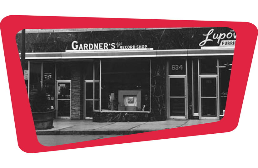An old black and white photo of Gardners record shop. The front of the building is a black marble texture with large windows and window pane doors.