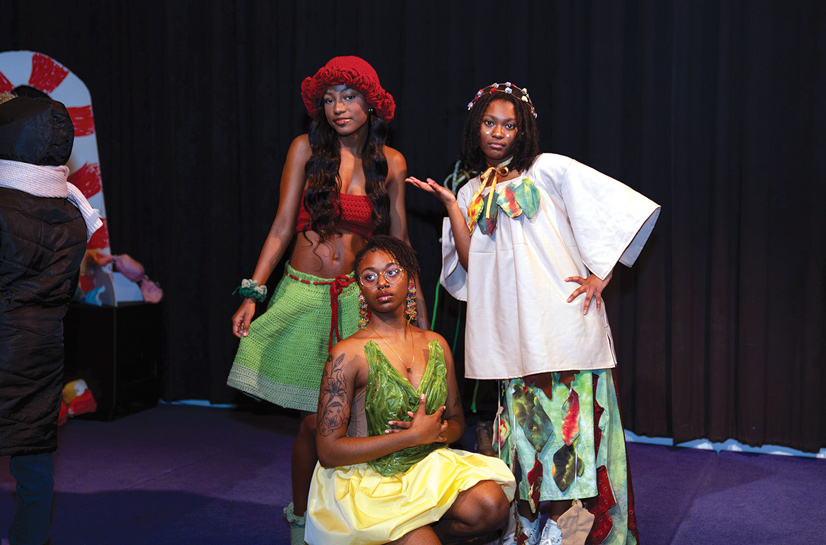 three women posing for a photo dressed in colorful garb