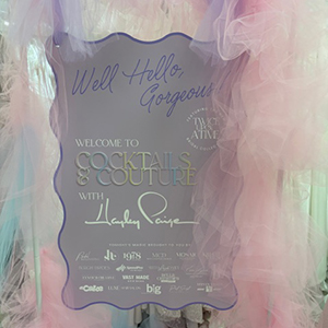 pastel fabric around sign for wedding dress event
