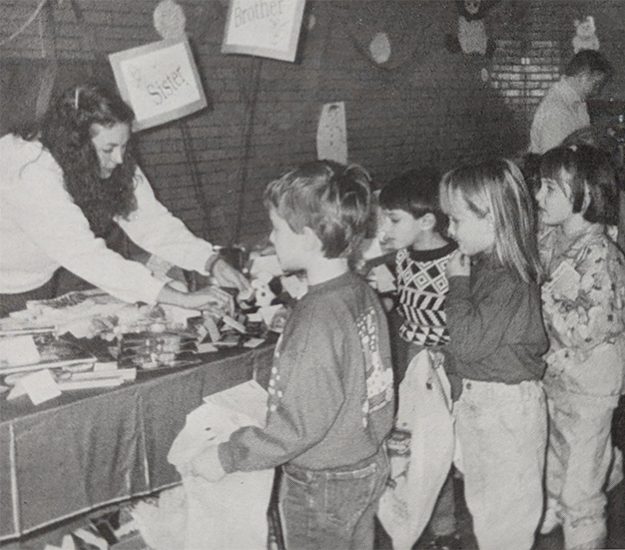 black and white photo of kids and adult in school shopping for holiday gifts
