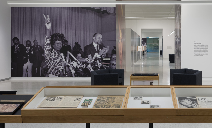 A display of images and archived newspaper articles and different mediums in a museum for Black Photo Journalism.