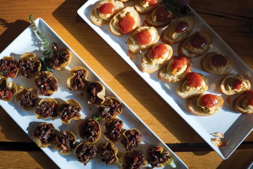 two types of horduerves on white plates, one on pita bread and one on crostini