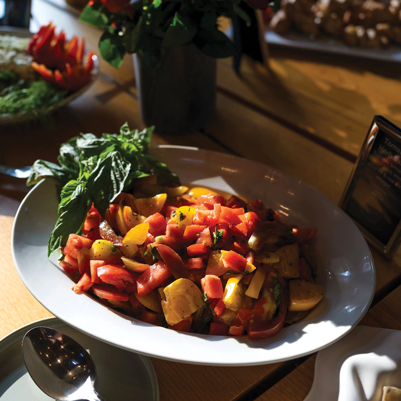 tomato and herb salad in a white bowl