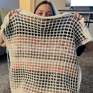 woman holding crochet blanket