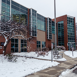 exterior of mt lebanon public library, building with brown brick and large windows during the winter with snow