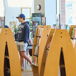 young man standing in library