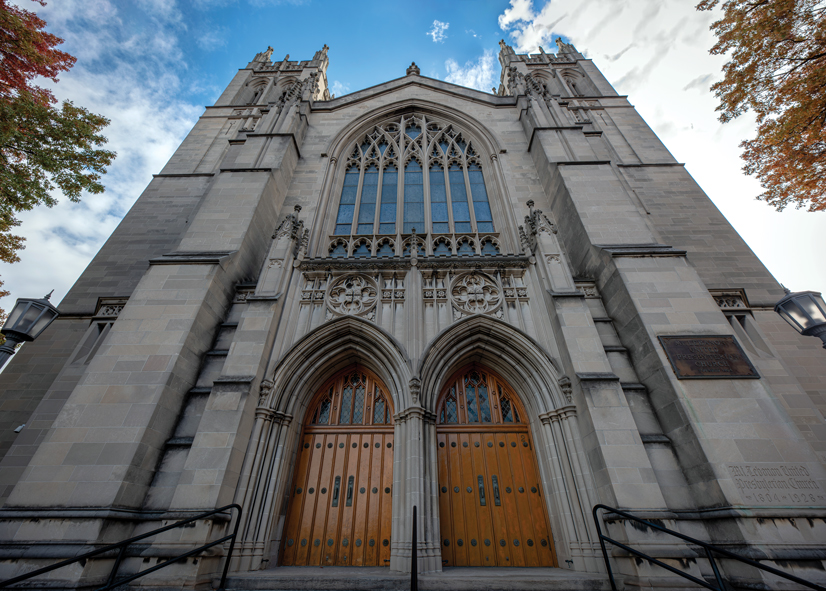 a gothic style stone church, with detailed architecture and large windows and doors