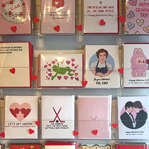 valentine's day cards on display in a storefront