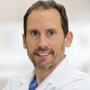 headshot of man in white doctor coat