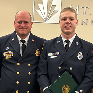 two firefighters in navy blue uniforms