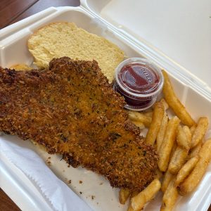 fried fish, fries, bun, ketchup in styrofoam container