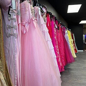 pink dresses on a rack in a store