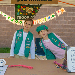 girl scouts in uniform at a table