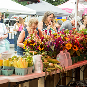 people shopping at outdoor farmers market